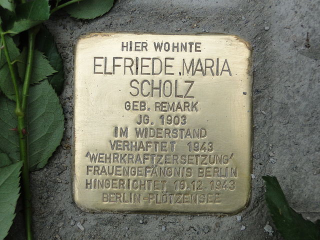 Stolperstein für Elfriede Scholz Elfriede Remark kam - fünf Jahre nach ihrem Bruder, dem späteren weltbekannten Schriftsteller Erich Maria Remarque - als jüngstes von vier Kindern des Buchbinders Peter Franz Remark (1867-1954) und der Anna Maria Remark, geb. Stallknecht (1871-1917) zur Welt. Als Kind kränkelte sie häufig. Sie war infolge eines Mangels an roten Blutkörperchen und wegen schwacher Knochen zwei Jahre lang gelähmt.Trotzdem absolvierte sie eine Schneiderlehre. Eine 1923 geborene uneheliche Tochter starb nach wenigen Monaten an Herzschwäche.Über die damalige Modemetropole Leipzig 1926 und Berlin kam sie schließlich nach Dresden, wo sie sich 1929 als selbständige Damenschneidermeisterin niederließ. 1941 heiratete sie dort den bei der Kriegsmarine dienenden Musiker Heinz Scholz.<br />
<br />
Wie ihr Bruder war sie eine überzeugte Ahntifaschistin. Eine Aussage gegenüber einer Kundin, dass der Krieg doch verloren sei, führte nach Denunzierung und Anzeige wegen „staatsfeindlicher Äußerungen“ durch den Hauptmann Hans-Jürgen Rietzel bei der Gestapo zu ihrer Verhaftung.